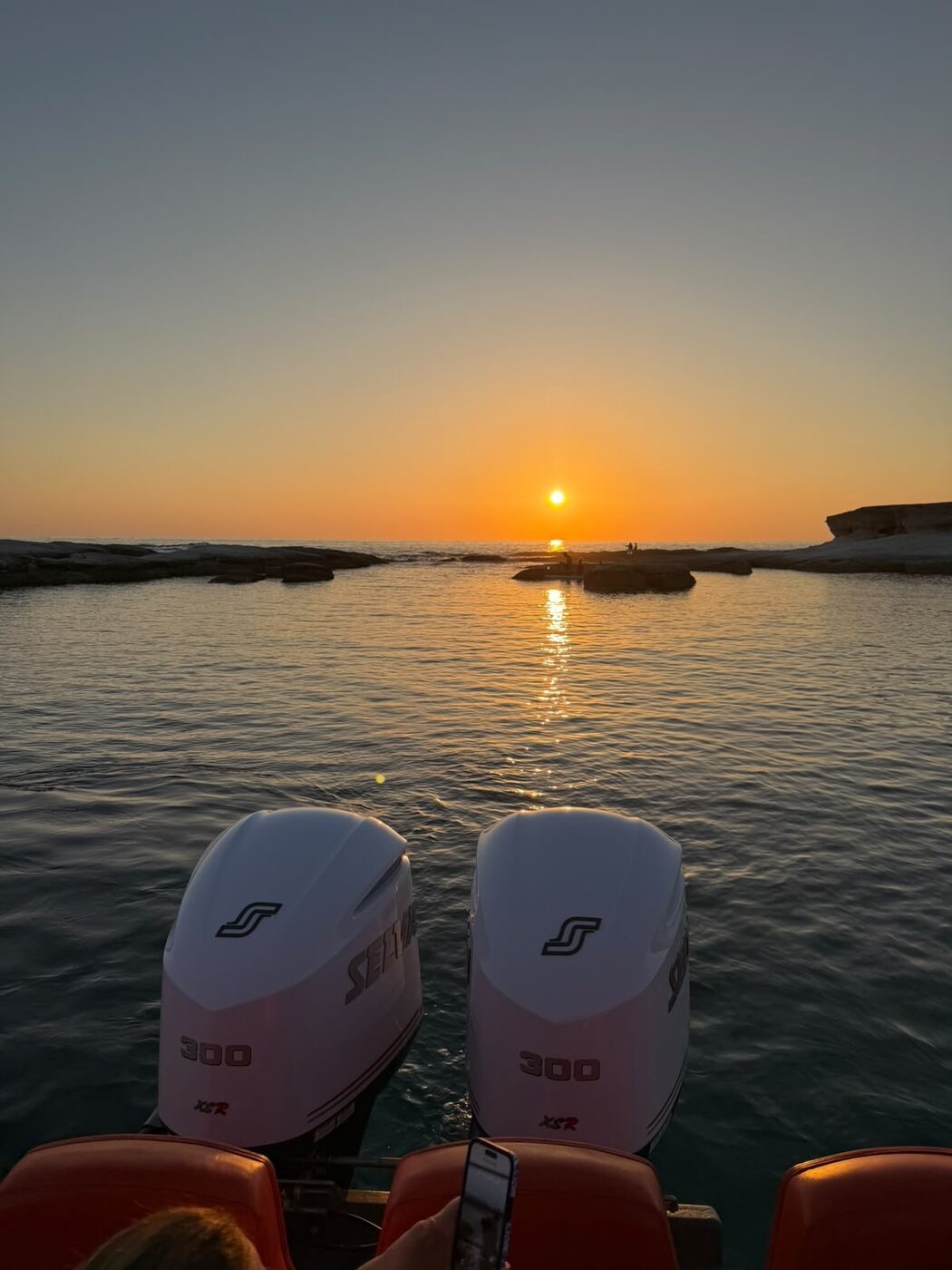 Sunset over the sea framed by the twin Selva engines of SharaBADanga